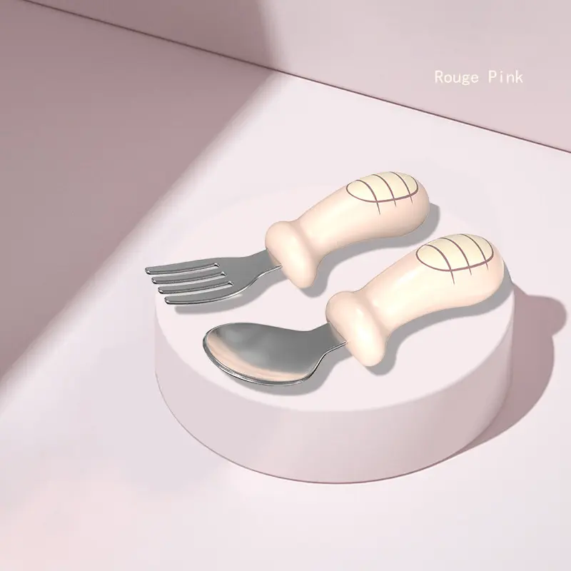 Baby pink cutlery with ergonomic silicone handles